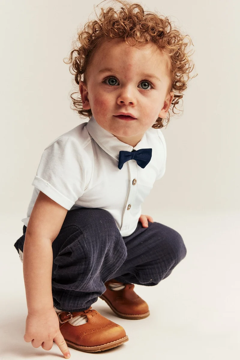 Baby white short-sleeved bodysuit with bow tie