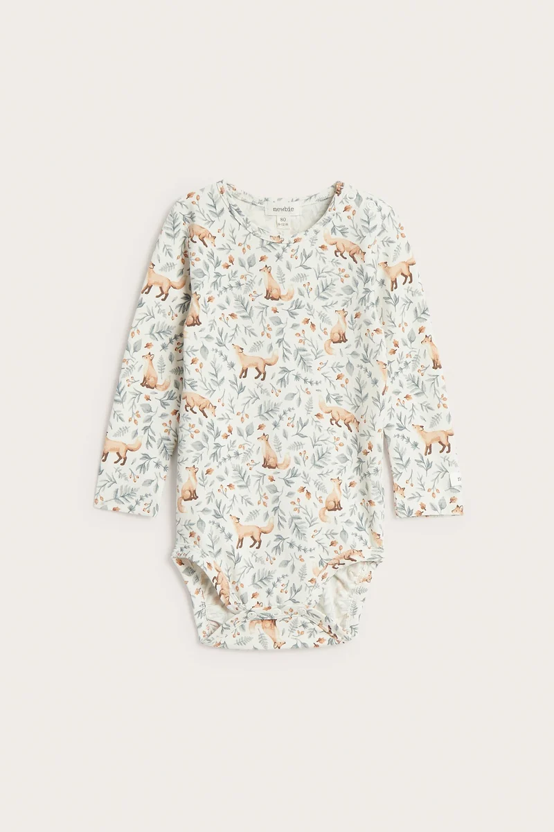 Baby white bodysuit with all-over pattern