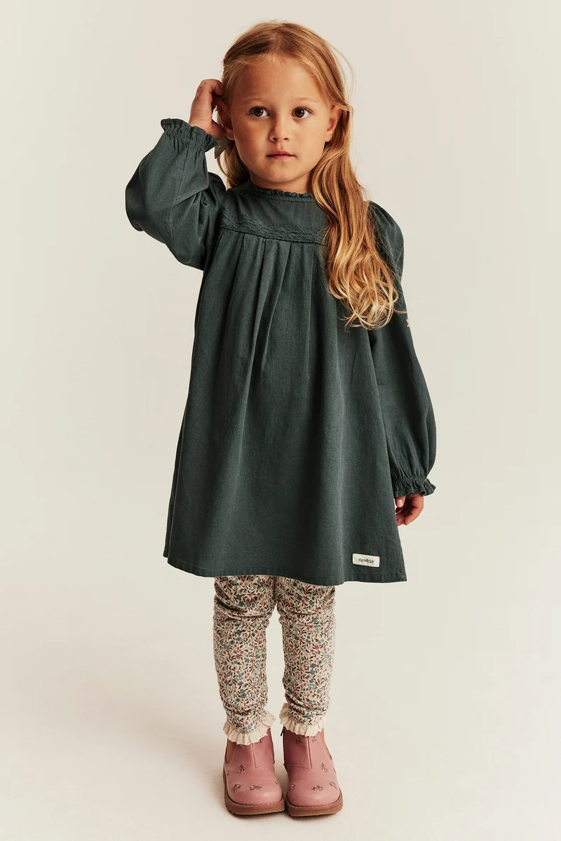 Kids green dress with cross-stitch embroidery